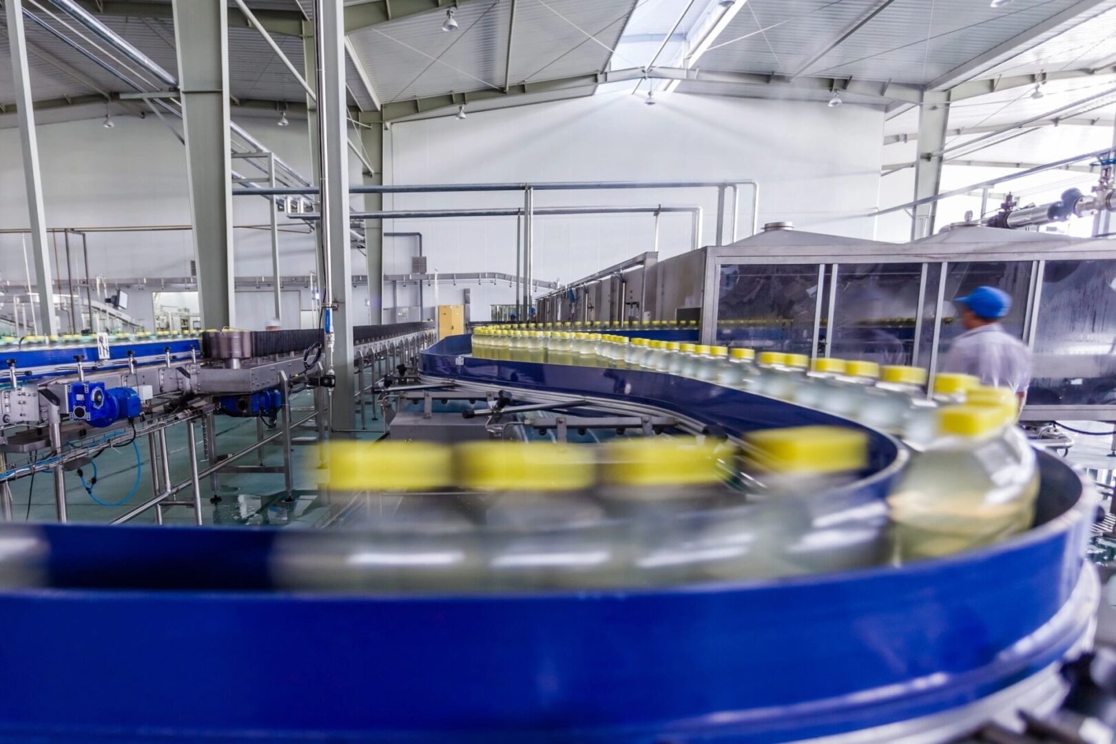 A conveyor belt with many cans of beer on it.